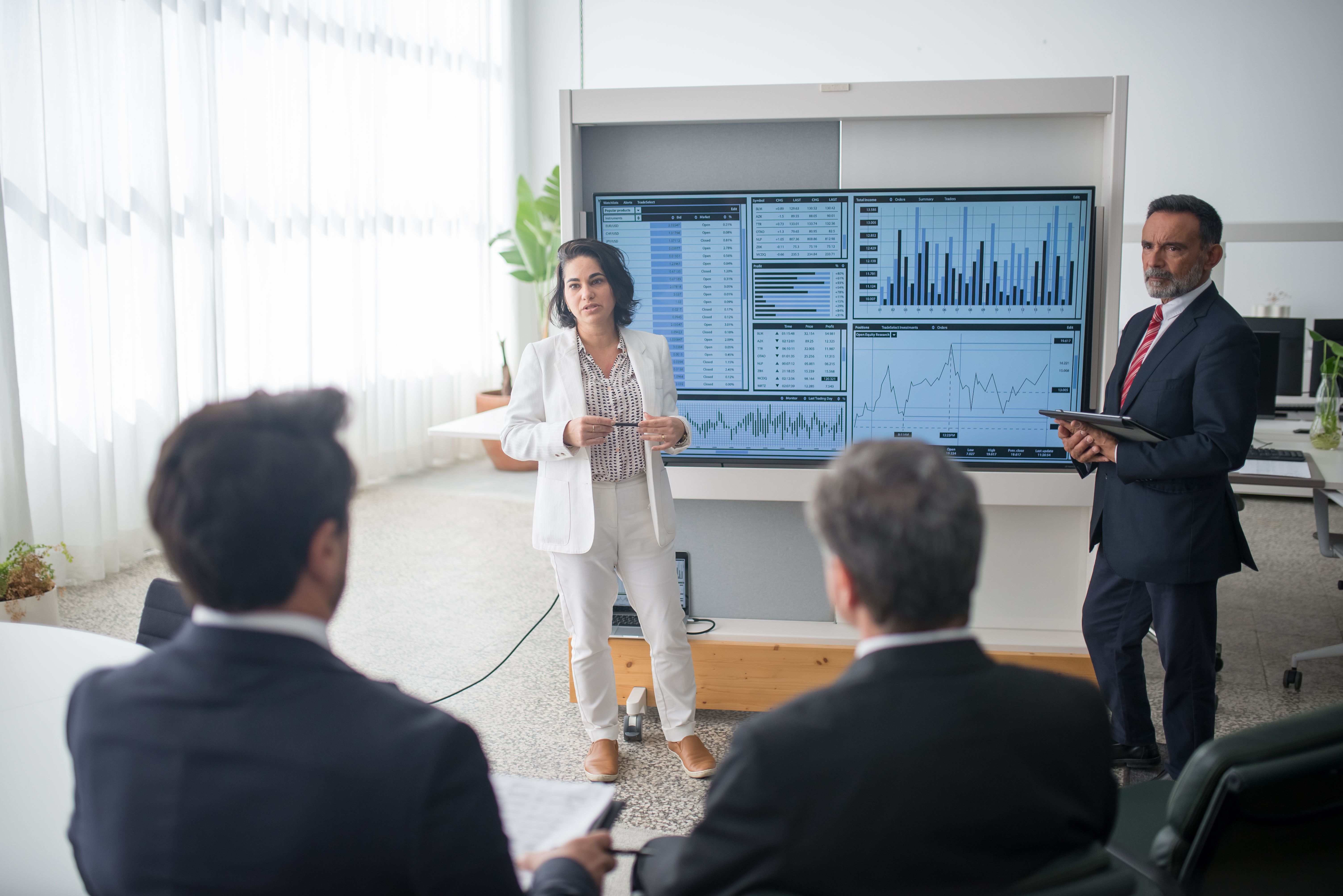 Consultants presenting work around a table